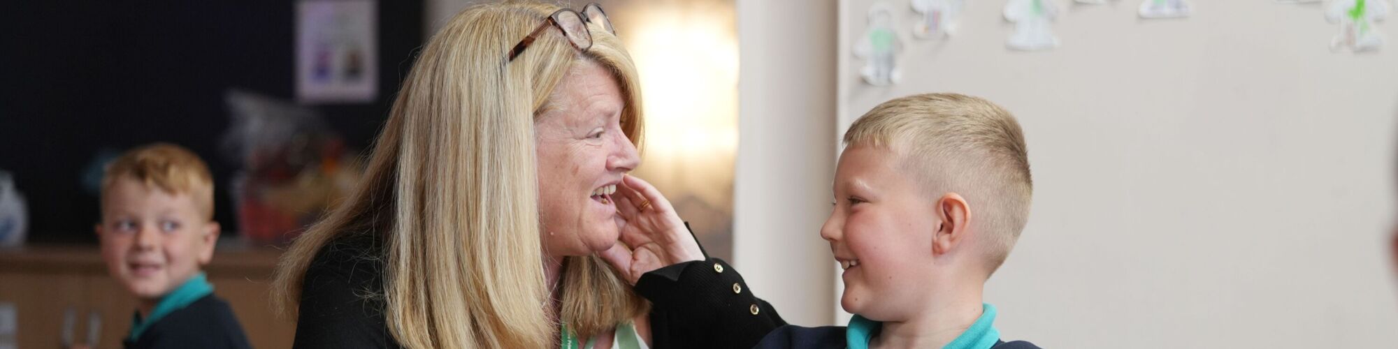 Oxclose Primary Academy teaching helping a pupil with his work